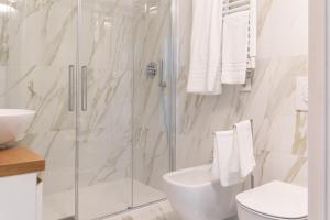 a bathroom with a shower and a toilet and a sink at HomeThirtyFour in Verona