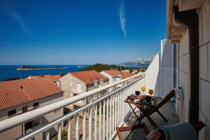 a balcony with a view of the ocean and buildings at Apartments Maruna in Cavtat