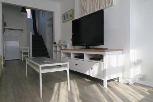 a living room with a television on a white cabinet at Seaside House Broadstairs by the Beach with Parking in Broadstairs