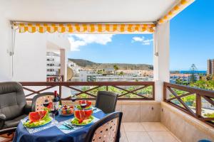 a balcony with a table with watermelons on it at 228 CHIC STUDIO 'San Marino' SPECTACULAR TERRACE in Los Cristianos