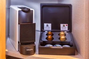 a drawer of a refrigerator with a coffee maker and muffins at Hotel Faro, a Lopesan Collection Hotel - Adults Only in Maspalomas
