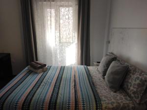 Ein Bett oder Betten in einem Zimmer der Unterkunft Dormir en Cádiz