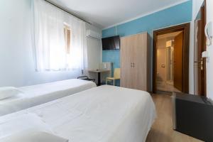 a hotel room with two beds and a window at MH Hotel Benaco in Peschiera del Garda +43 photos