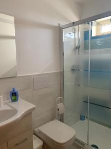 Un baño con inodoro y ducha de cristal. en A... Mare Sicilia, en Marina di Modica 33 fotos más