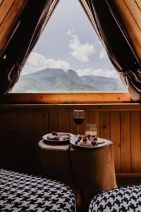 a table with two plates of food and a glass of wine at Willa Malinowa in Zakopane