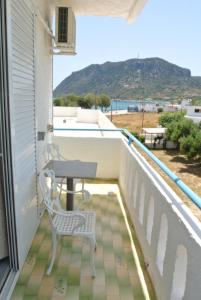 a patio with a table and chairs on a balcony at Kokalakis Hotel in Kefalos