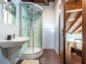 a bathroom with a glass shower and a sink at Maty's House - Dreaming Holiday in Gonnesa