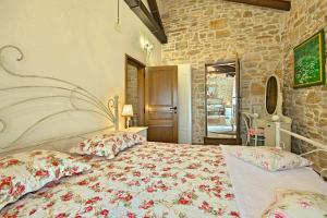 a bedroom with a large bed with flowers on it at San Niccolo 2 in Vilanija