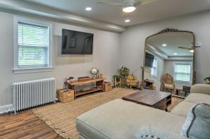 a living room with a couch and a mirror at Takoma Park Apt with Wood Fire Pit Less Than 8 Mi to DC in Takoma Park