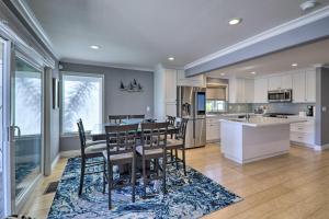a kitchen and dining room with a table and chairs at Discovery Bay Retreat with Balcony and Boat Dock! in Discovery Bay