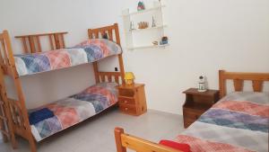 a room with two bunk beds and a table at Loutra House Kythnos in Loutra