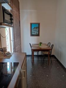 eine Küche mit einem Tisch und Stühlen im Zimmer in der Unterkunft Hotel La Pineta in Cogoleto
