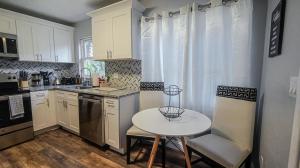 a kitchen with a table and a small table and chairs at Elegant Cozy Oasis on a traffic free street in Clearwater