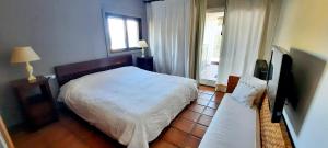 Ein Bett oder Betten in einem Zimmer der Unterkunft Villa Puerto Blanco