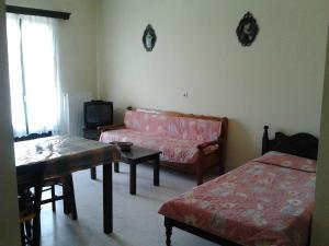 a living room with a couch and a table at Elektra Apartments & Studios in Petra