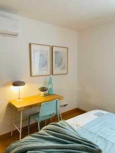 a bedroom with a desk and a bed and a table at Fantástico apartamento T2 a 2min do acesso à praia CozyIn Cabanas in Cabanas de Tavira