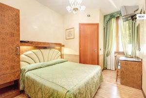 A bed or beds in a room at Atlantide Hotel