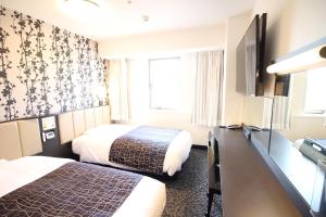 Katil atau katil-katil dalam bilik di APA Hotel Beppu Ekimae