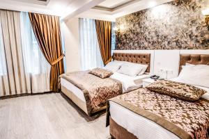 a hotel room with two beds and a window at Lazz City Hotel in Istanbul