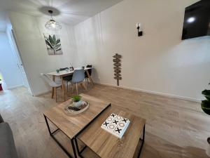 a living room with a table and a dining room at LE COSY Résidence du Golf in Deauville +26 photos