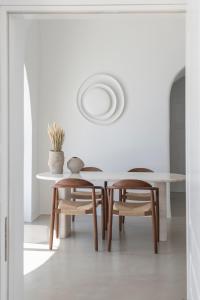 a dining room with a table and two chairs at Villa Dio in Firostefani