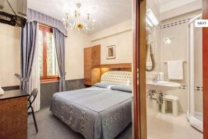 A bed or beds in a room at Atlantide Hotel