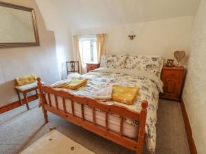 a bedroom with a bed with a wooden frame at Beehive in Matlock