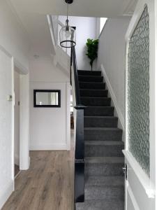 a stairway with a black rail and a stair case at Croyden villa in Blackpool