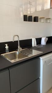 a kitchen with a sink and a counter top at LightHouse in Albissola Marina +66 photos