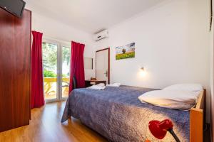 a bedroom with a bed and a large window at Villa Sunce in Sukošan +61 photos
