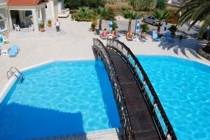 an overhead view of a swimming pool with a wooden bridge at Hotel Villa Basil in Tsilivi