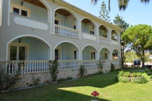 a large white house with a balcony at Hotel Villa Basil in Tsilivi