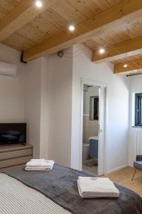 a bedroom with a bed with two towels on it at Masseria Piana Cimino in Pietra Montecorvino