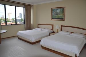Postel nebo postele na pokoji v ubytování Hotel Sagres