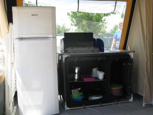 a refrigerator and a table in a tent at camping yaso-guara in Yaso
