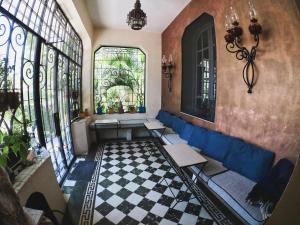 a living room with a blue couch and windows at La Perla Hotel Boutique B&B in Guadalajara