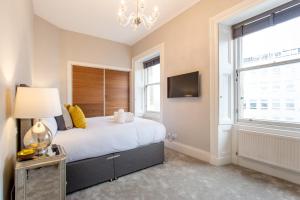 a bedroom with a large bed and a window at Exclusive 2 Bed, Free Private Parking, in West End in Edinburgh