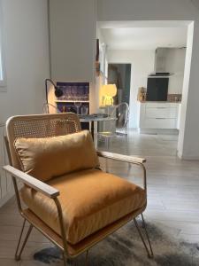 a living room with a chair and a table at Maison Angers La Madeleine Rooftop in Angers