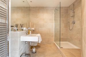 a bathroom with a sink and a shower at Exclusive 2 Bed, Free Private Parking, in West End in Edinburgh +28 photos