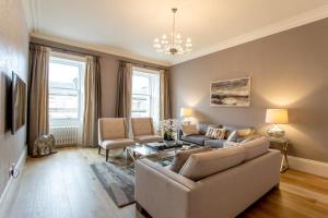 a living room with a couch and a table at Exclusive 2 Bed, Free Private Parking, in West End in Edinburgh
