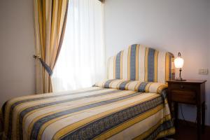 Posteľ alebo postele v izbe v ubytovaní Dimora Palazzo La Fenice