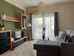 a living room with a couch and a tv at Antonis Kavros appartment in the center of chania in Chania