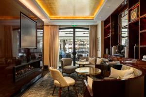 a hotel lobby with a fireplace and chairs at Hotel Montaigne in Paris
