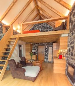 a living room with a loft with a staircase at Palheiros do Serrado by Real Vision in Estreito da Calheta
