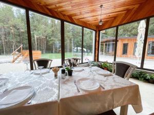 a table with white plates and napkins on it at Doftana Nature Events in Trăisteni