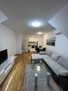 a living room with a couch and a table at Apartman Anton in Zagreb