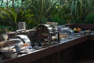 a kitchen counter with a sink and plates and dishes at Alevic Hotel Sirmione in Sirmione