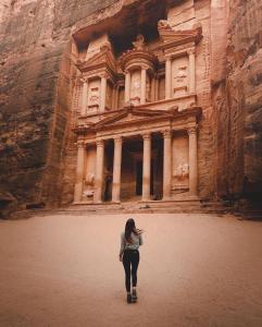 a woman standing in front of a building at La Bella BedoUina in Wadi Musa