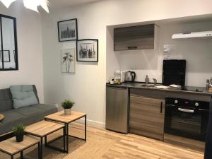 sala de estar con sofá y cocina en Loft Archi au centre de Nevers, en Nevers