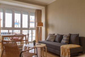 a living room with a couch and a table at La Portada in Seville